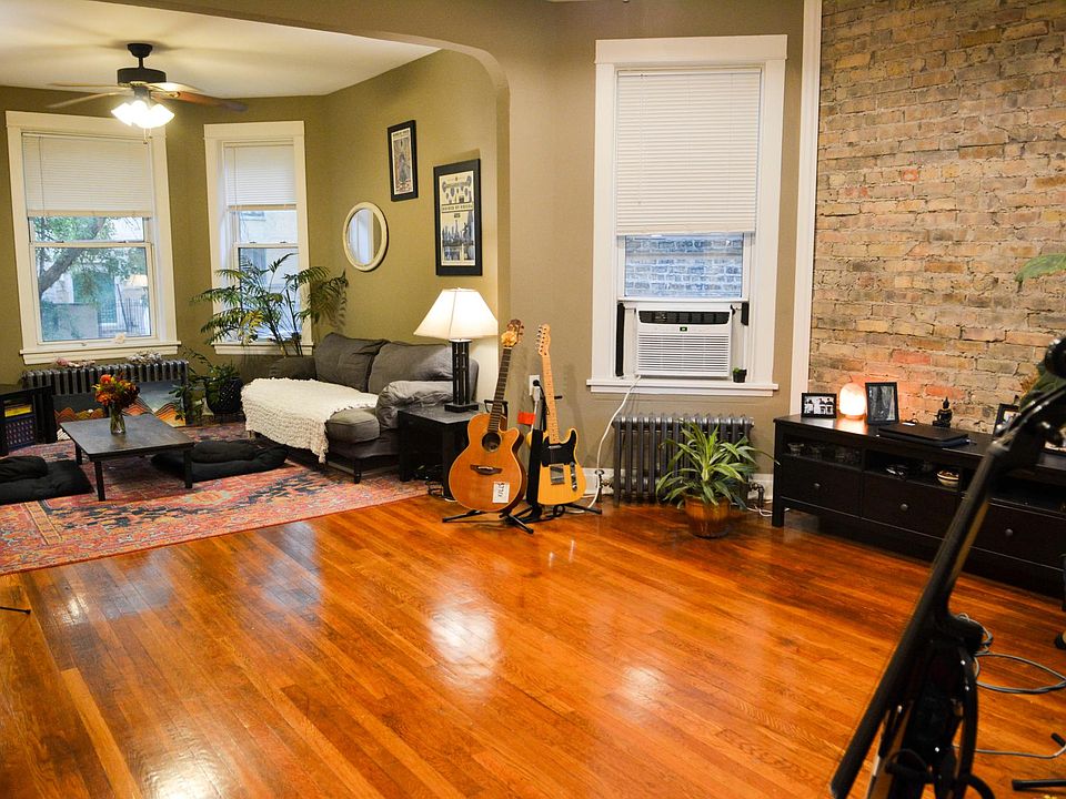 Living/dining room with exposed brick.