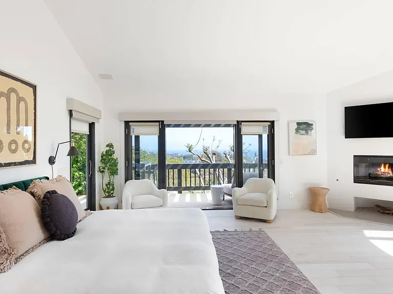 Master bedroom overlooking the backyard oasis and Pacific Ocean Views.