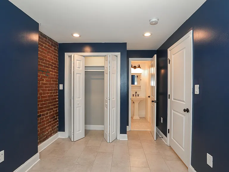 Modern Entryway and Hallway with Exposed Brick Accent