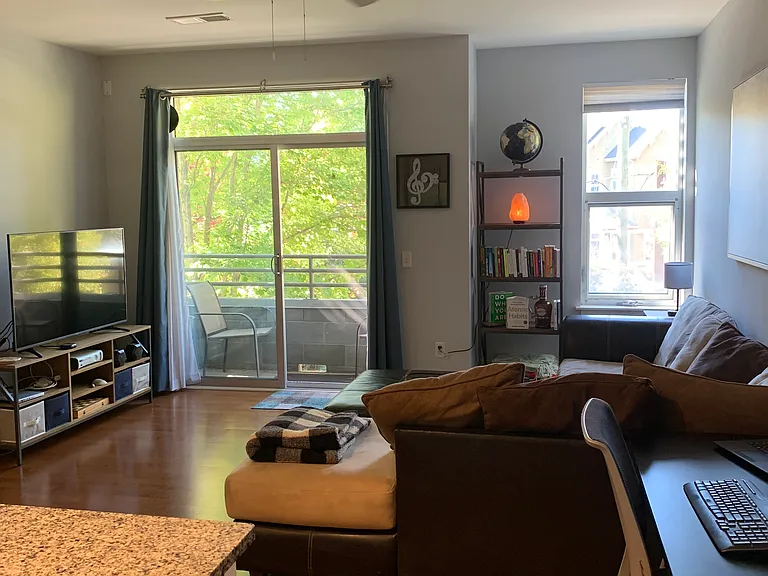 From the kitchen looking into the living area. You can see the sliding glass door and balcony