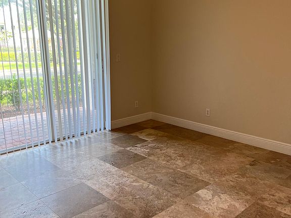 Master bedroom with Travertine Natural Stone floors including in the walk-in closets and fresh new paint including baseboards.