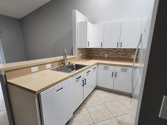 Kitchen with new fridge, new stove, new dishwasher.