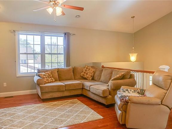 Another photo of the living room that an abundance of natural light.
