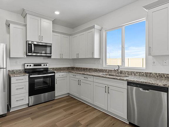 Enjoy stunning granite countertops and designer cabinetry in this kitchen.