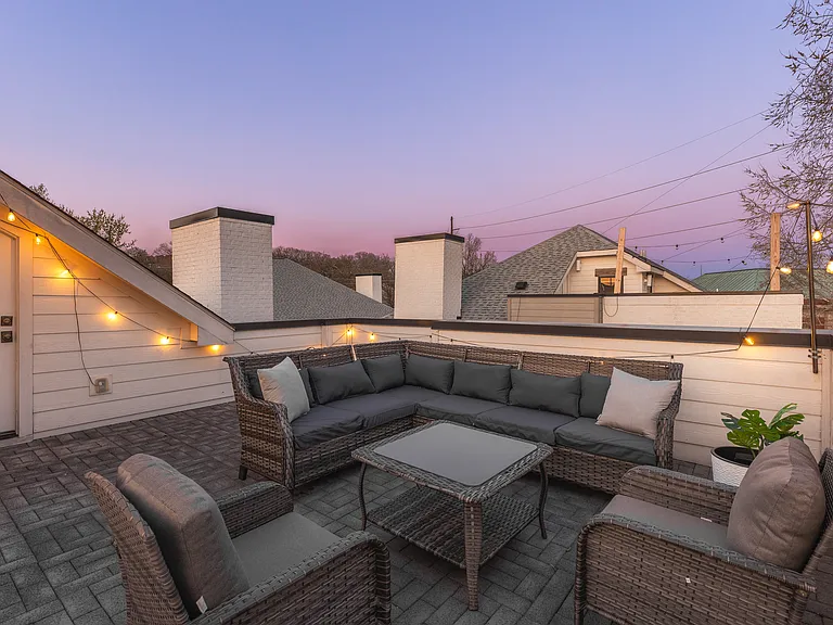 Private rooftop deck with plenty of seating and outdoor lights, allowing you to enjoy your morning cup of coffee or a late night conversation while overlooking the skyline.