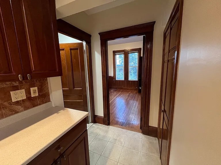 Passage from kitchen to bathroom (L), first floor bedroom (C), walk-in pantry/closet (R)