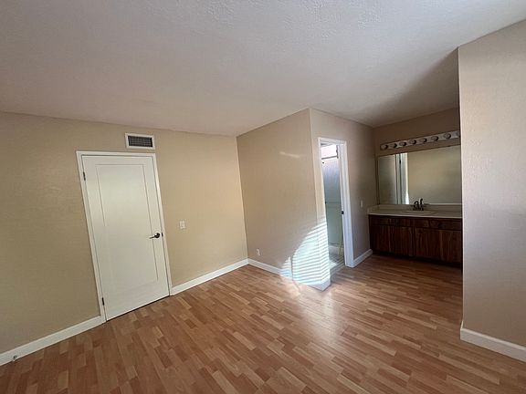 Master Bedroom with a view toward master bath with showers and toilet