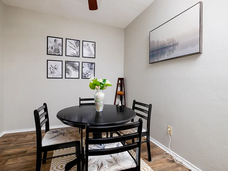 Cozy dining area with a round table for 4, plus additional seating for 2 at the kitchen island_perfect for meals, coffee, or conversation.