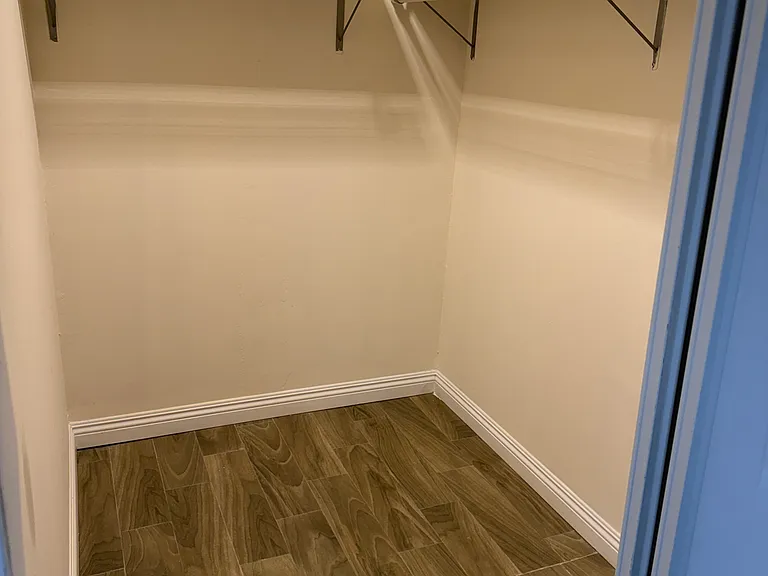 Primary bedroom walk in closet