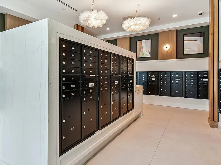 Griffis West Palm apartments mail room with mailboxes and parcel lockers.