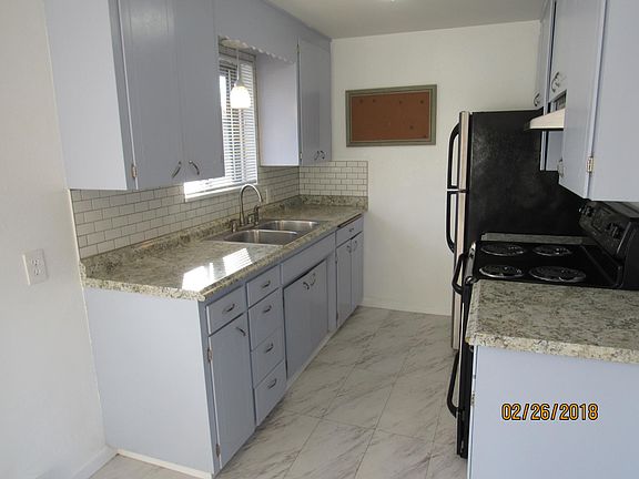 Kitchen features modern appliances and new custom tile backs