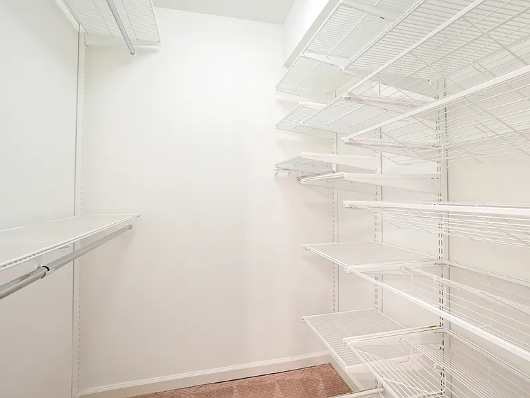 Walk in closet with closet system.