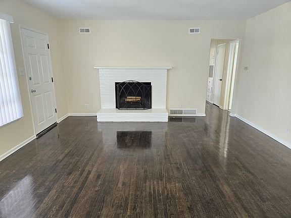Large living room with Fireplace, Hardwood Flooring that opens into the Bedroom hallway...