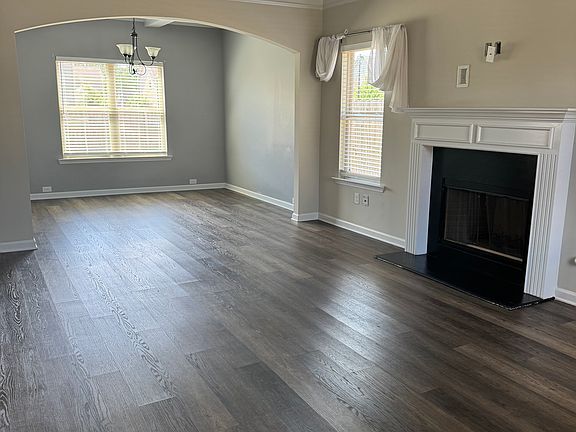 Entrance of the home including the living room, fireplace, and bonus dining room.