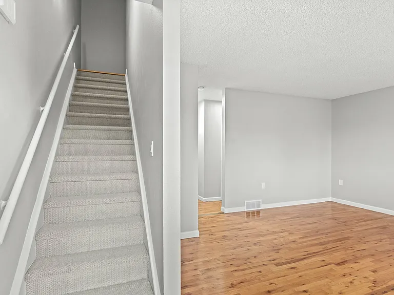 Step into elegance with this airy apartment, showcasing a welcoming staircase and open living space. Step into elegance with this airy apartment, showcasing a welcoming staircase and open living space.