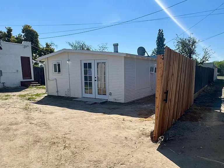 Private parking off of alley with a roll-away fence that is lockable. Back yard shared space with front house. Private side yard West of building.