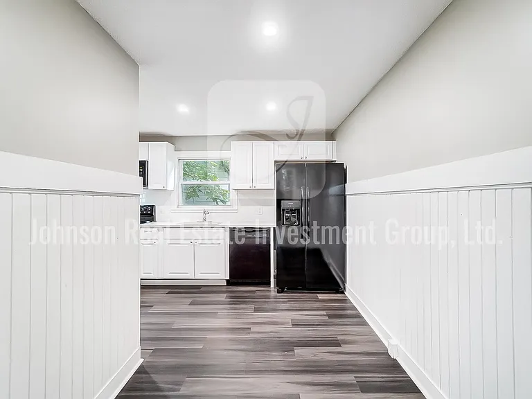 Stunning remodeled kitchen with black appliances and white quartz countertops!
