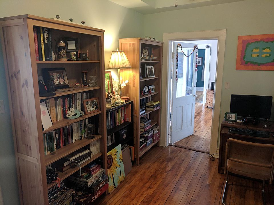 This is bedroom 2 which has two entrances, one to the living room and the other to the kitchen .