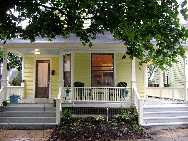 Curbside view of house with shared front porch