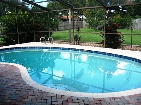 pavers around the high-screened pool