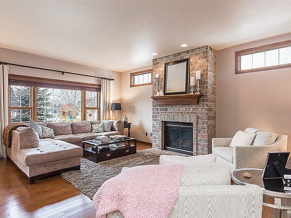 Great room with gas fireplace overlooking backyard.