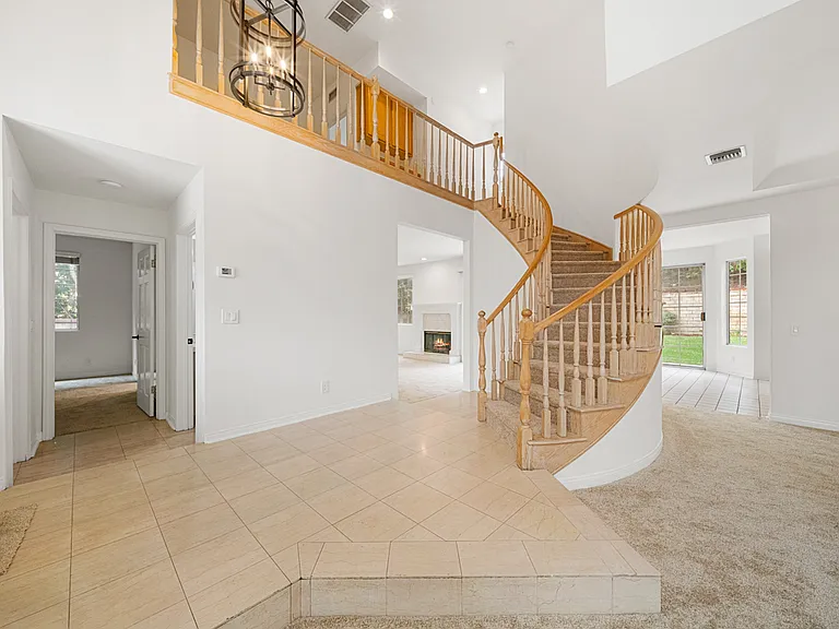 Front Entrance with Winding Staircase and Vaulted Ceilings
