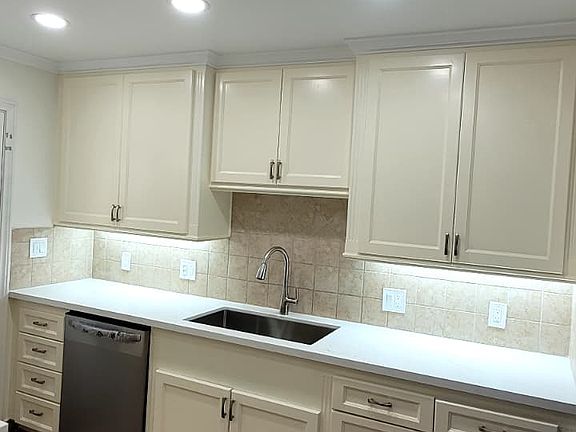 Newly painted kitchen, new countertops, sink, and new appliances (refrigerator, oven and dishwasher).