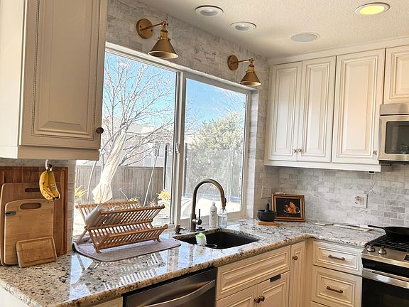 View of the large expansive back yard with custom deck.
