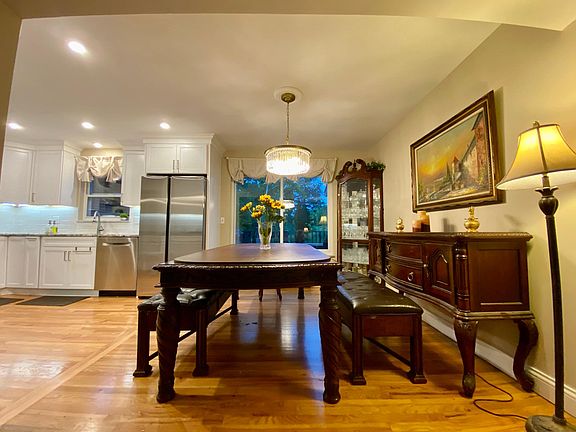 second dinning area next to kitchen, large windows to the private back yard and deck