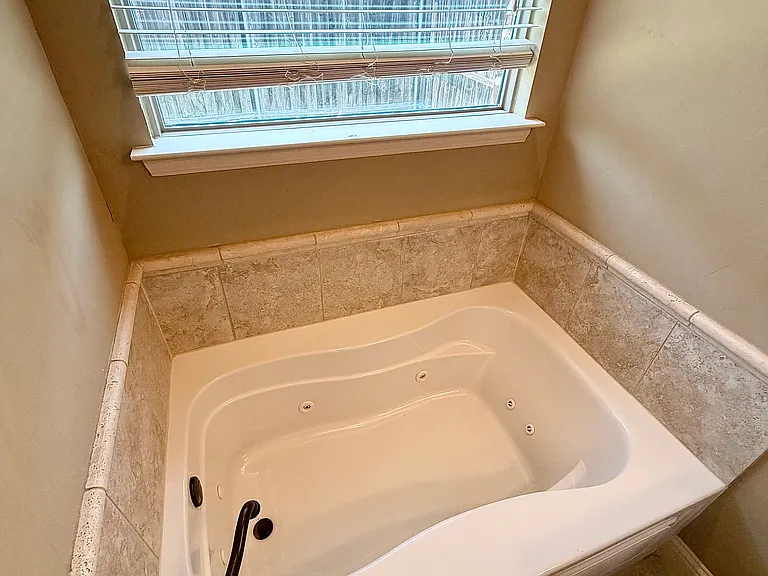 Primary bedroom connected bathroom with shower and tub