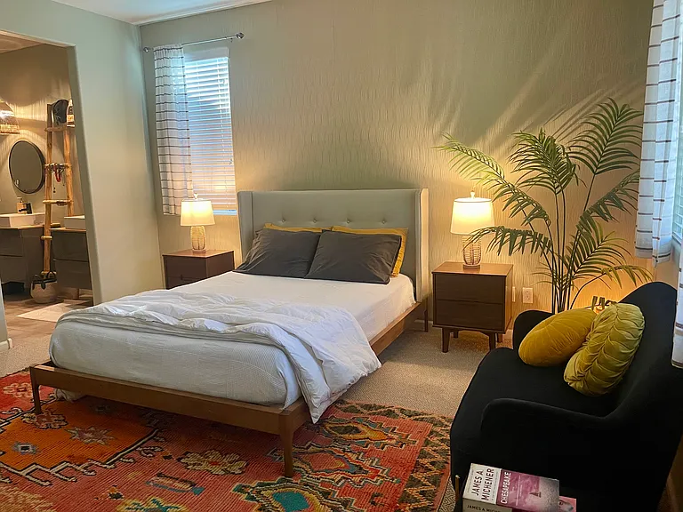 Primary Suite. Queen sized bed. Perfect for morning coffee or just reading a book. Includes wall-mounted TV.