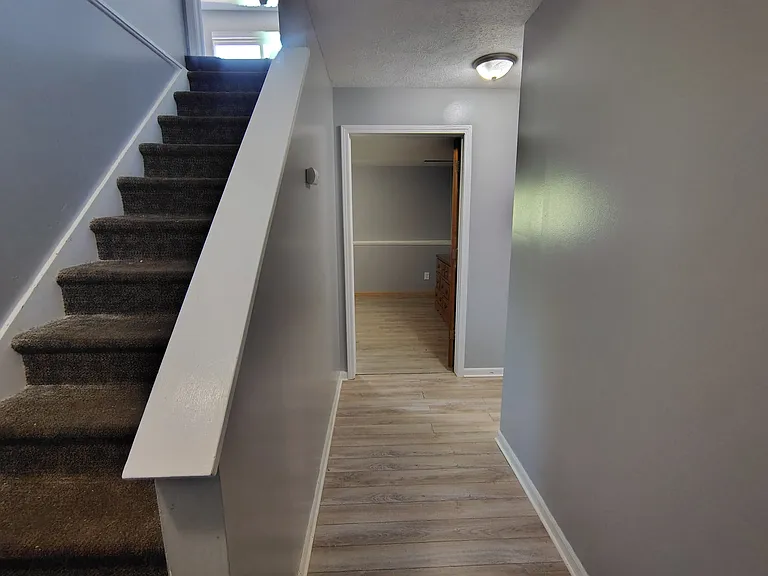 Downstairs to 2 beddrooms and bathroom with shower stall