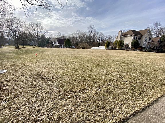 Left of the house, side yard