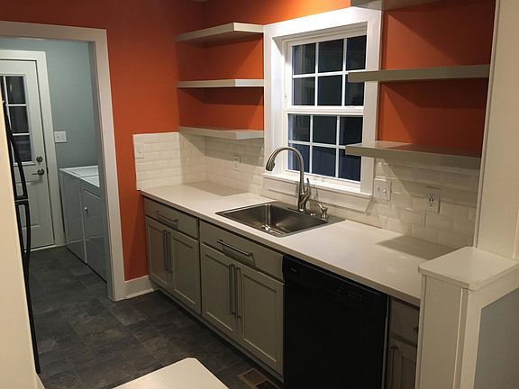 Galley kitchen; washer/dryer on right prior to door, which leads to large back deck.
