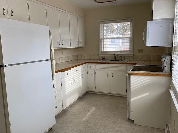 Kitchen. Lots of light. Lots of cabinets. Range, oven, microwave, refrigerator-freezer. There's a closet left of the fridge.