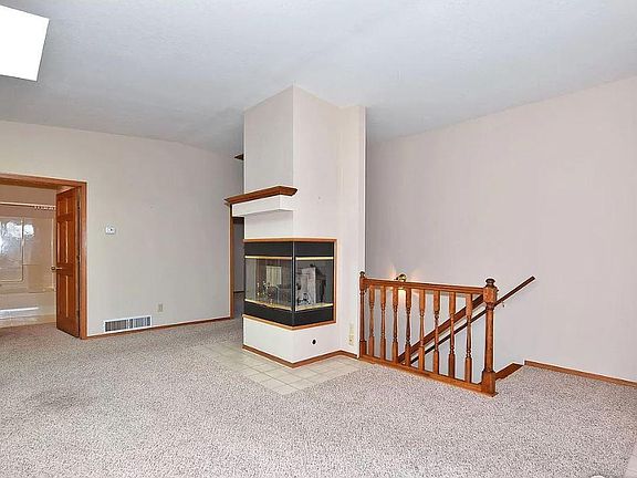 Entry/living room with a view of shared upstairs bathroom