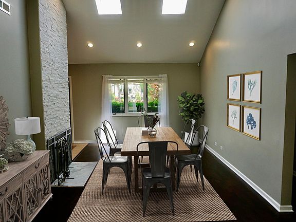 Dining room; photo taken from living room and facing the front of the house. Two bedrooms, full bathroom and laundry are to the right.