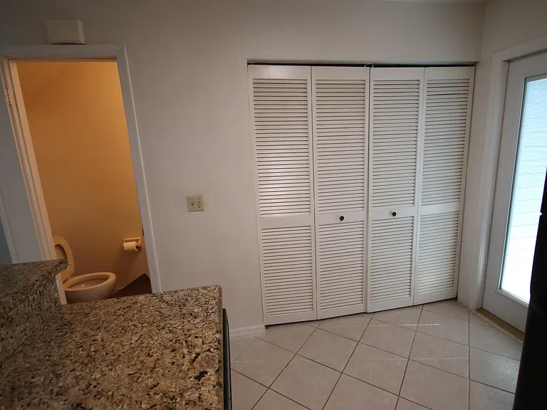 Bi-fold doors to full size washer & Dryer. Downstairs half bath.