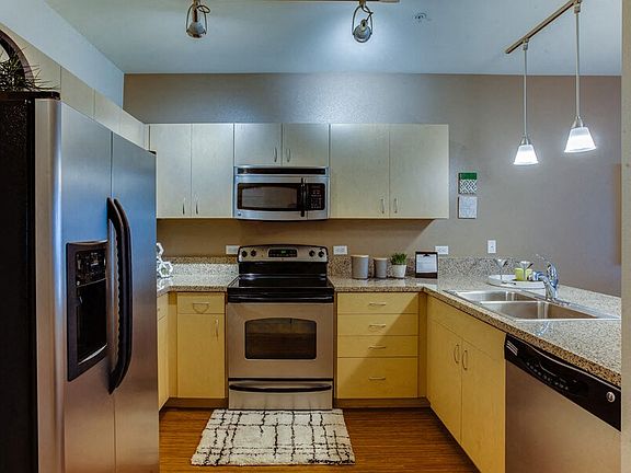 Open kitchen features beautiful granite countertops with six inch granite backsplash and luxury vinyl plank flooring