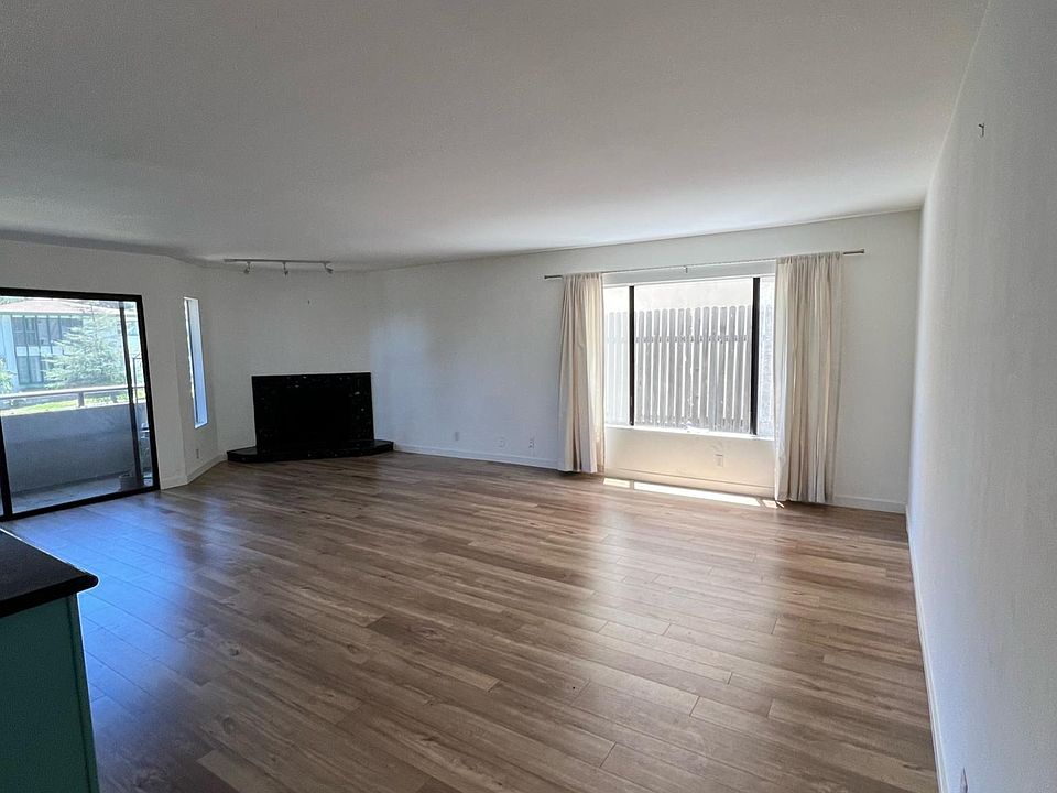 Living room 

(Context: kitchen to the left, dining room behind, and hallway to bedrooms/bathrooms to the right)