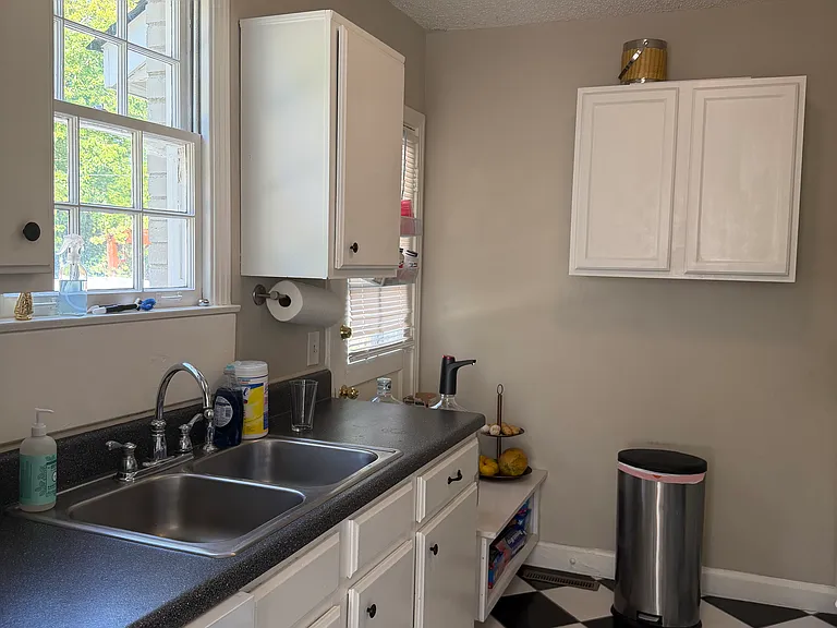 Kitchen with Black and white tile, new dishwasher, side-by-side refrigerator