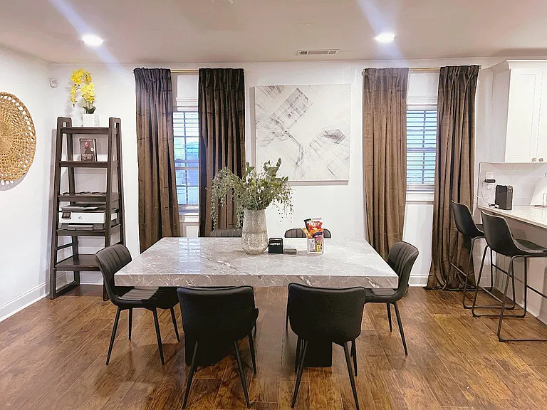 Dedicated dining area with a full-size table, seating for six, and adjacent breakfast bar for casual meals.