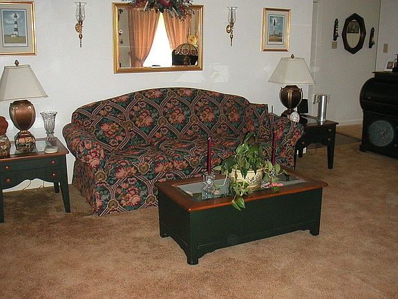 Spacious living room with fireplace and back deck access