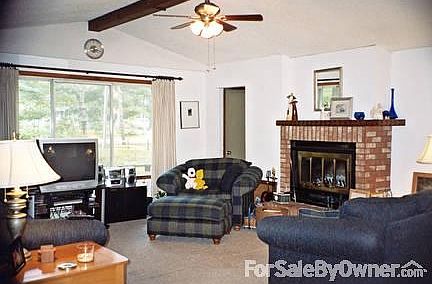 Living Room
						:
						Cathedral ceiling, wood fireplace with blower, and ceiling fan.