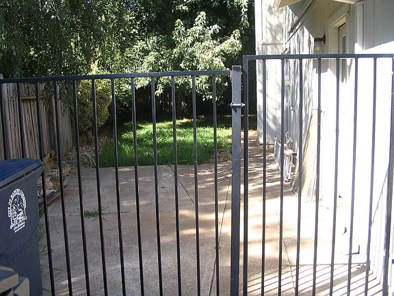 Side patio with iron gate
