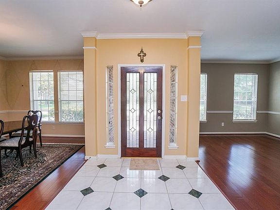 This home has many designer touches including custom tile in the entry hall which splits the formals.