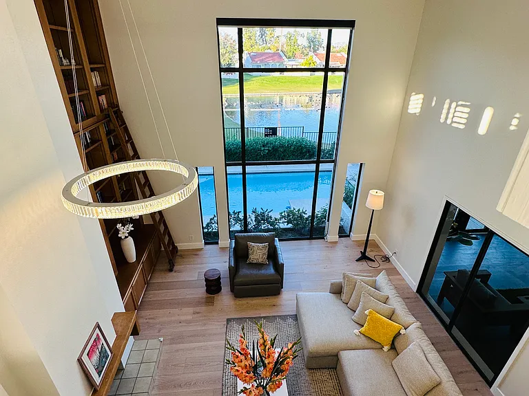 Breathtaking living space defined by soaring, double-height ceilings and big windows blending the indoors with the stunning natural beauty outside.