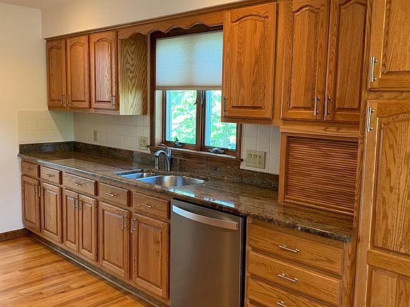 Hardwood floors in kitchen, dining area, and hallways