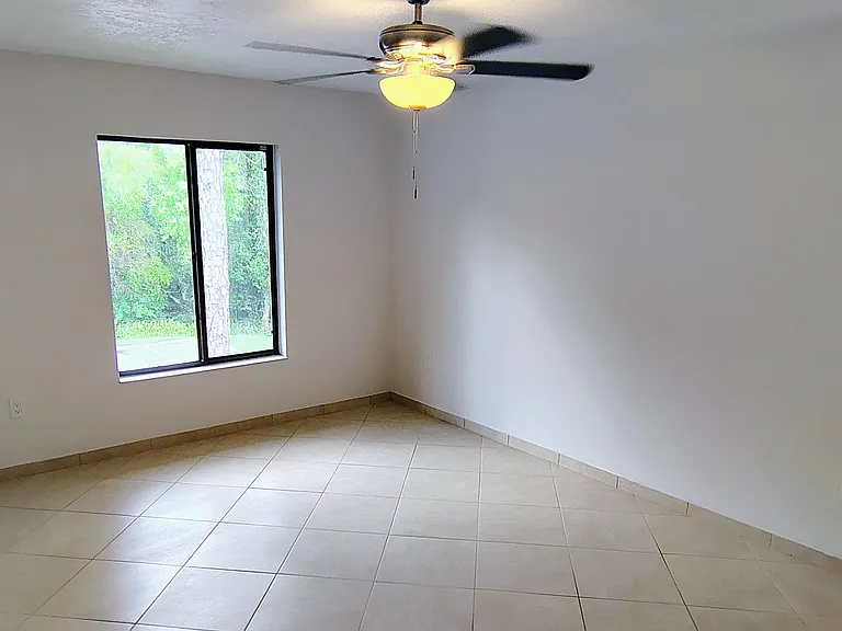 Main bedroom w/view of preserve; new ceiling fan