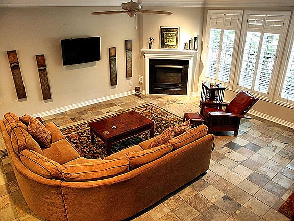 Overview of living room taken from the stairs. Owner will consider leaving pictures on this wall.